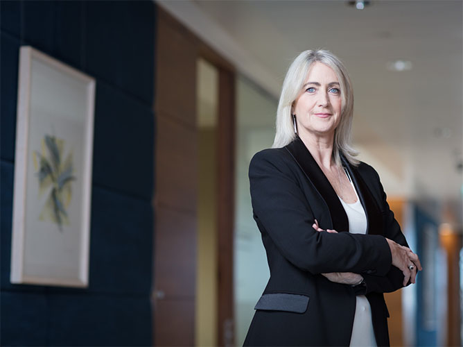 michelle o'keefe of goodbody investments standing with arms folded