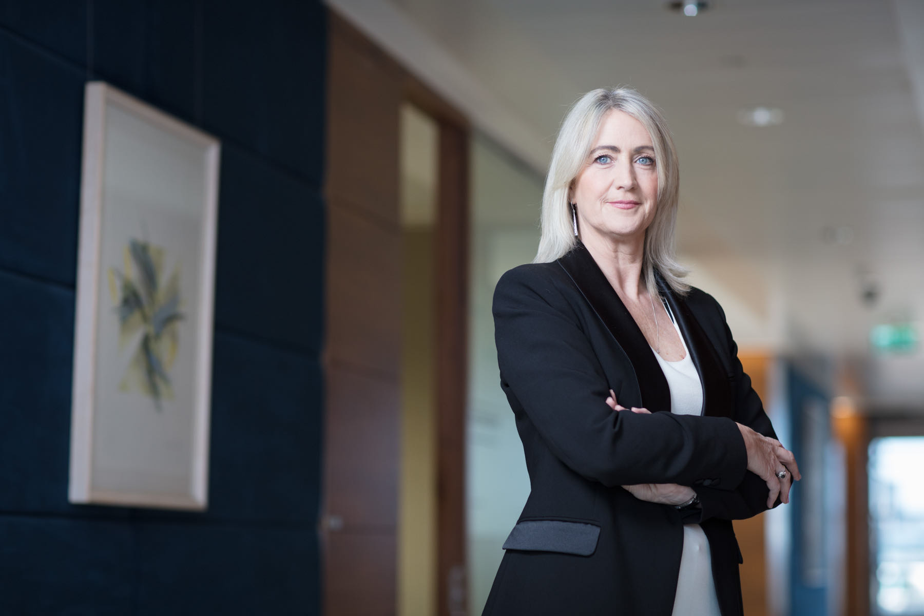 michelle o'keefe of goodbody investments standing with arms folded