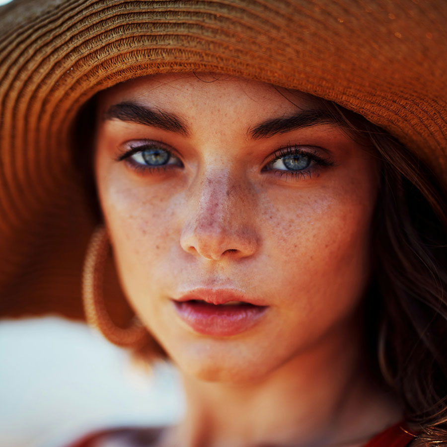 Woman with freckles wearing SPF in the sun